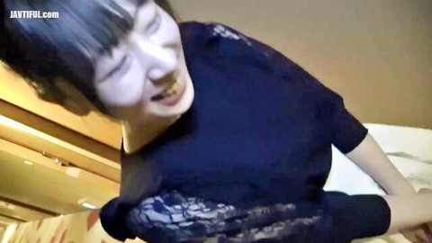 Busty Asian babe with F-cup tits in lacy black top, smiling in intense POV tease