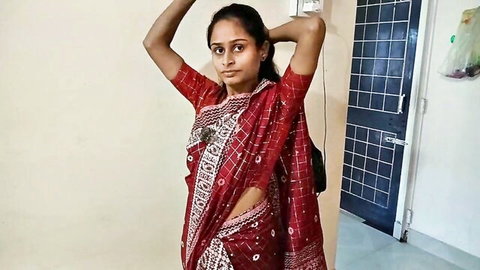 Desi bhabhi in red saree posing with arms up, teasing tight ass view