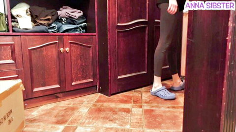 Stepsister in tight black leggings teasing her round ass in bedroom closet