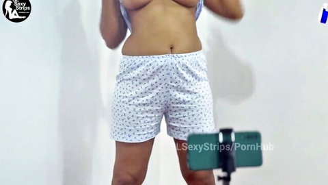 Indian woman lifting top to expose breasts in white shorts, solo amateur striptease