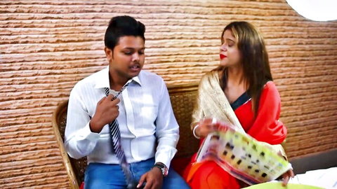 Indian desi wife in red saree chats intimately with husband on bench