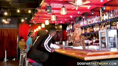 Busty blonde bartender in leopard top flirts with two black guys showing massive cleavage at bar