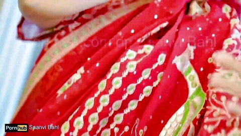 Sexy Indian bhabhi Poonam teasing in red saree with deep cleavage and curves