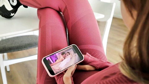 Kinky teen in tight pink leggings watches hardcore porn on phone, tight ass highlighted