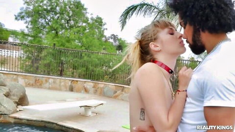 Angel Youngs topless with red collar kissing black stud Van Wylde by pool