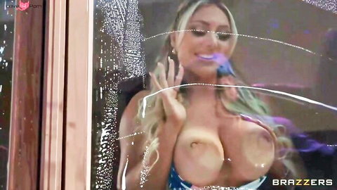 Blonde MILF with huge wet tits smiling behind steamy glass window