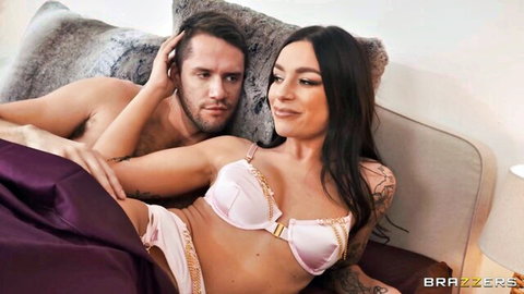 Curvy brunette babe with big tits in shiny pink lingerie cuddles shirtless hunk on bed