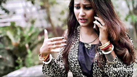 Sudipa Das in leopard print top on phone, seductive Indian beauty tease