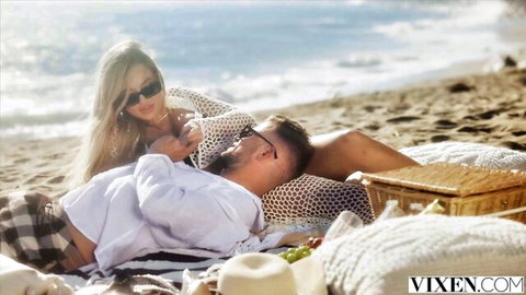 Blake Blossom in sheer crochet top lounging with boyfriend on beach picnic