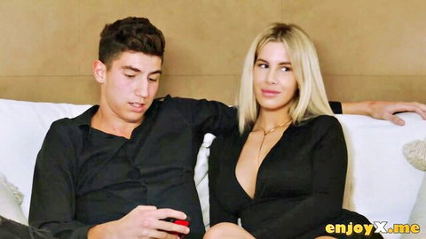 Anastasia Brokelyn in sexy black dress cuddling with guy on couch