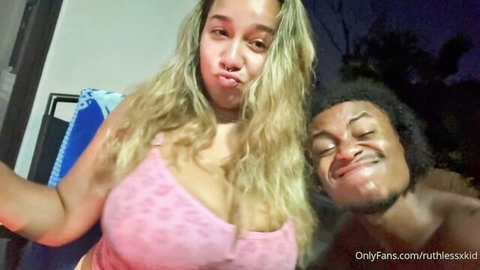 Curvy blonde with massive tits in tight pink top poses duck face with shirtless black guy outdoors