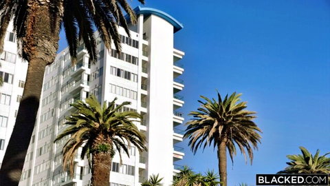 Goldie Ortiz beachfront apartment building in sunny outdoor scene from Brake Addiction