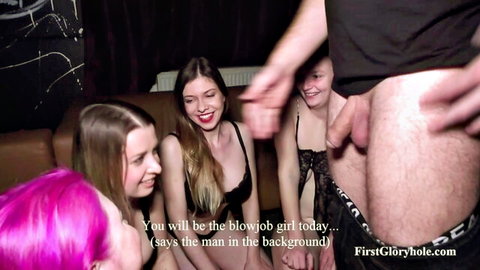 Group of slim Caucasian women in lingerie at glory hole gangbang blowjob setup