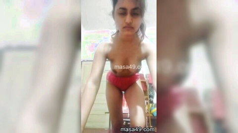 Topless Indian teen girl with small tits posing in red panties homemade solo