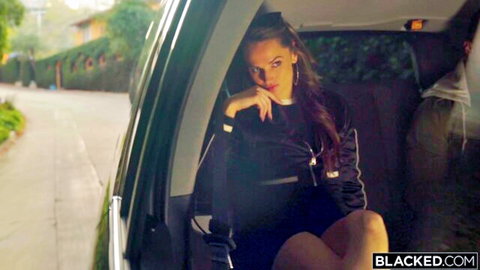 Tori Black in sleek black tracksuit leaning seductively from luxury car window