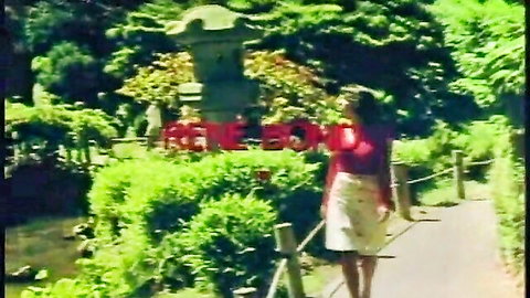 Rene Bond walks seductively in red top and white skirt through lush garden in vintage retro porn
