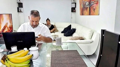 Indian chubby stepmom lounging seductively while stepson works at desk