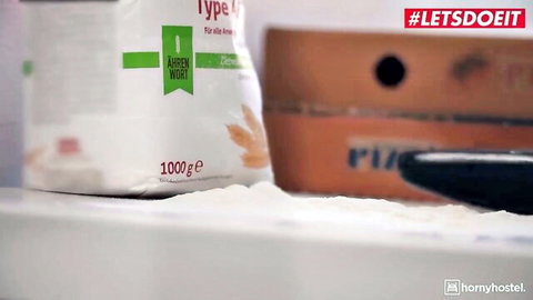 White bag of Type 550 flour spilled on kitchen counter next to box and spatula