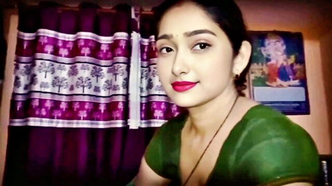 Sexy Indian Desi Bhabhi in green saree blouse with red lips smiling