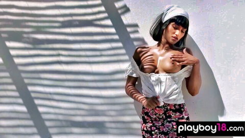 Petite Asian Angel Constance topless, squeezing orange on perfect tits