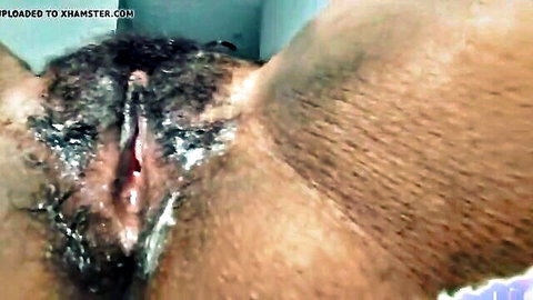 Close-up of ebony woman's hairy pussy, explicit wet view