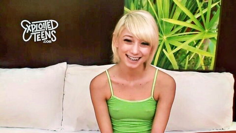 Smiling blonde teen with braces in green tank top, amateur style