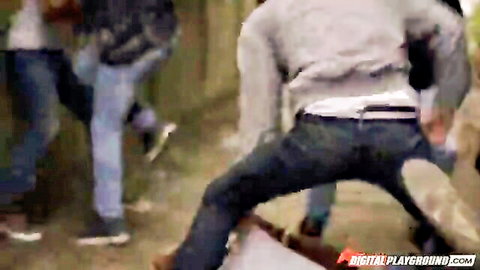 Group of clothed skater guys in jeans bending over skateboards outdoors at park