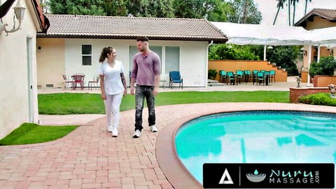 Busty tattooed Bella Blu in nurse scrubs teases client poolside for Nuru Massage