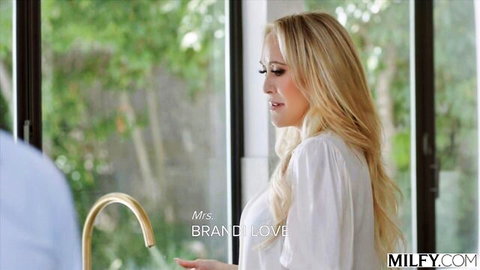 Brandi Love blonde MILF in white shirt at kitchen sink