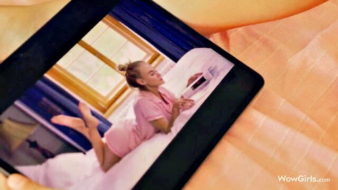Nancy A in pink lingerie lounging on bed in lesbian scene with Alissa Foxy
