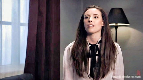 Casey Calvert in white blouse and black bow tie, seductive gaze
