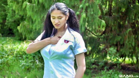 Desi teen in blue uniform touches neck seductively outdoors in park