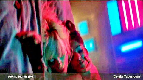 Blonde woman intimately kissing man in neon pink and blue club lights