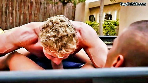 Muscular blond hunk giving intense blowjob poolside