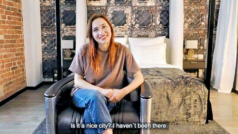 Redhead teen smiles in casual t-shirt and jeans during bedroom casting interview