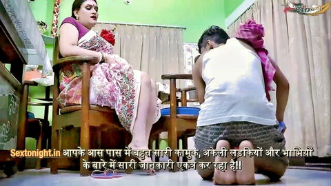 Indian housewife with big tits sits in saree as submissive guy kneels before her in living room
