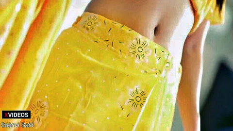 Sexy Indian woman in yellow saree exposing hot navel and toned belly