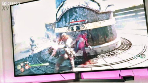 Intense Warframe battle scene with armored warriors fighting around rusty tower on TV screen