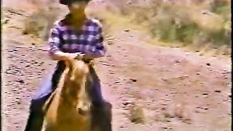 Vintage cowgirl in plaid shirt riding horse outdoors, 1984 Forbidden Fruit scene