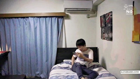 Asian guy sweaty t-shirt nipples peeking through, solo on bed with phone
