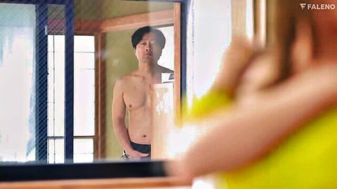 Shirtless fit Asian man in mirror reflection, toned abs and muscular build