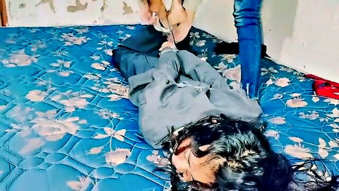 Bound and gagged Indonesian girl restrained on bed in amateur fetish scene