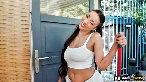 Vitoria Beatriz as sexy maid in white top and shorts, smiling with plunger