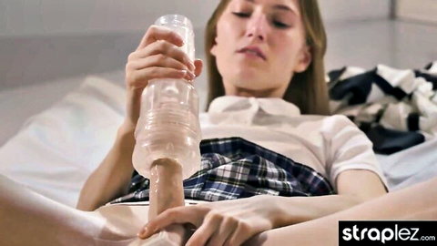 Blonde schoolgirl in uniform uses Fleshlight on strapless dildo until it squirts