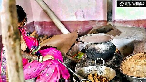 Desi busty woman in pink saree cooking, teasing cleavage in kitchen