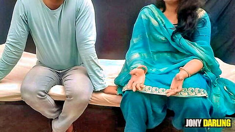 Indian couple in blue saree and casual wear sitting on bed teasing for taboo sex