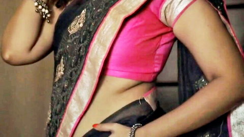Sexy Indian MILF in pink blouse and black saree, midriff exposed pose