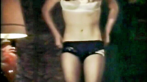 Retro blonde posing topless in black panties, vintage Tabu Film style