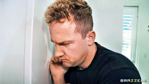 Handsome blonde man leaning against wall in black shirt, Brazzers massage scene