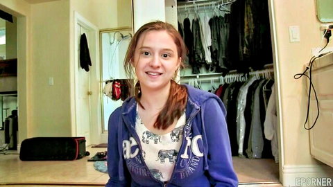 Smiling skinny brunette teen in purple hoodie during amateur bedroom audition